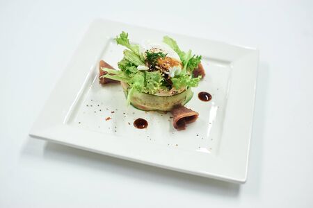 A plate of food on a white surfaceの写真素材