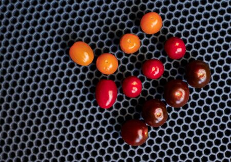 close-up of cherry tomatoes on a black backgroundの写真素材