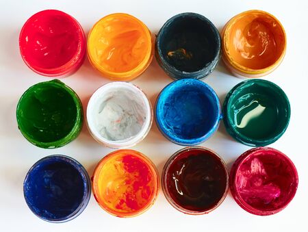 paints multicolored on a light background close-up horizontally from aboveの写真素材