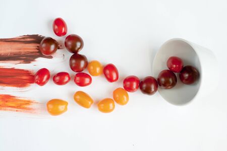 Colorful tomatoes on a white background scatteredの写真素材