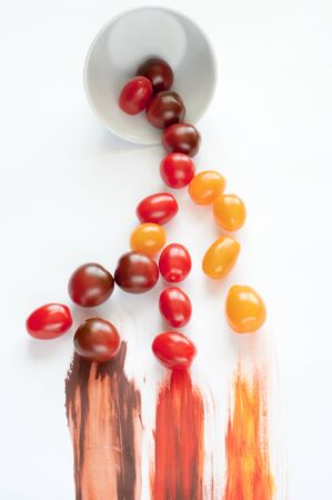 Colorful tomatoes scattered and painted with paintの写真素材