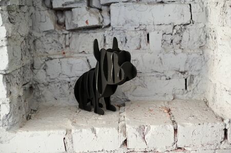 Dog figure on white brick background filmed horizontallyの写真素材
