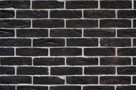 black wall of bricks removed horizontally to write textの写真素材