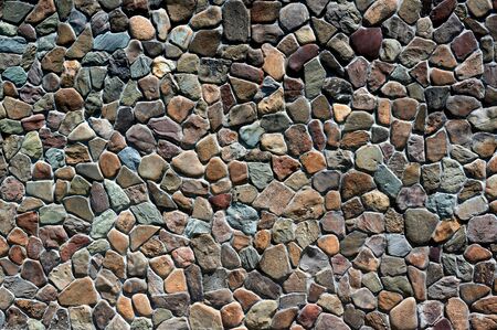 of different stones and sizes stone old wall horizontally close upの写真素材