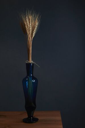 spikes in a vase on a black background verticallyの写真素材