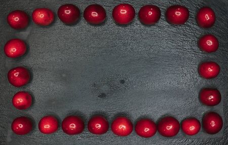 cherry frame on a black background. Place to write a textの写真素材