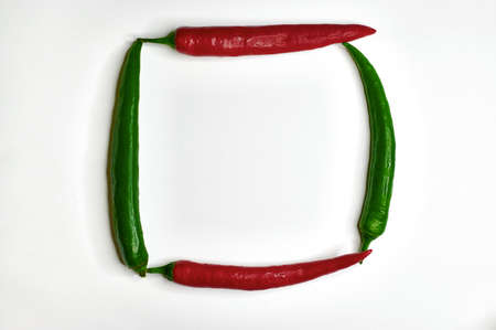 chilli spicy red and green bitter squared on a light background close-up topの写真素材