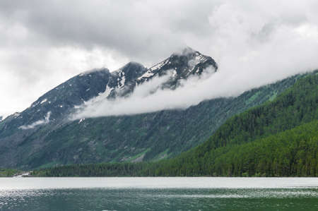 lake against the backdrop of the Altai Mountains and the clouds that hang. High quality photoの写真素材
