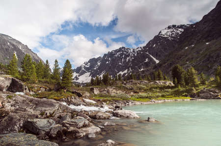 multi-mountain lakes against the backdrop of the Altai Mountains, blue sky with clouds, Altai Mountain . High quality photoの写真素材