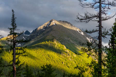 Sunlight falling on the Altai Mountains through the clouds. High quality photoの写真素材
