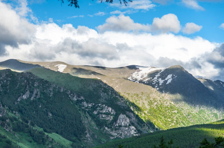 Altai Mountains with falling sunlight and blue sky with clouds . High quality photo