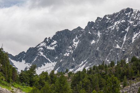 snowy cliffs with overcast skies in the Altai Mountains