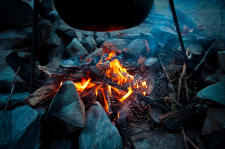 cooking at the stake of food in the mountains at sunset