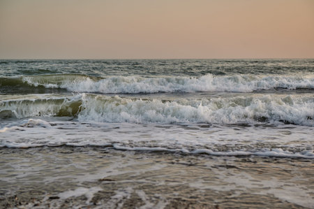 waves close-up on the black sea in the evening at sunset horizontal photoの写真素材