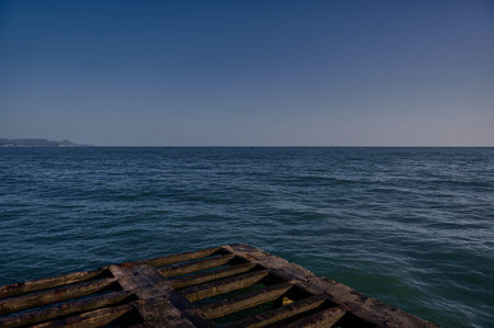 horizontal photo of a view of the Black Sea and the coast from the base of the pier at sunsetの写真素材