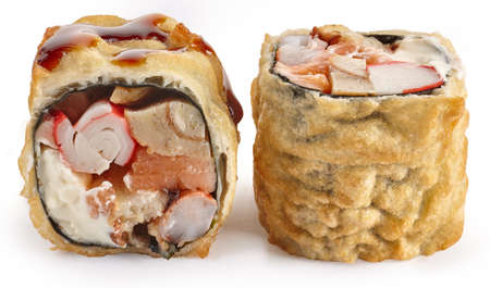 Tempura sushi roll with smoked eel, shrimp, salmon, Japanese omelette and Philadelphia cheese on a white backgroundの写真素材