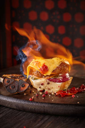 Fire Burger with cheese, onion and hot pepper in the interiorの写真素材