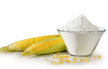 Open cob of fresh ripe corn on a white background with snow-white corn starchの写真素材