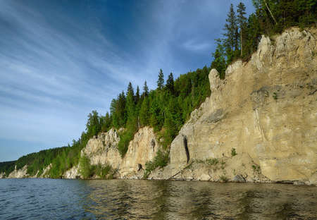 Landscape with a rock , river blue sky in the clouds.の写真素材