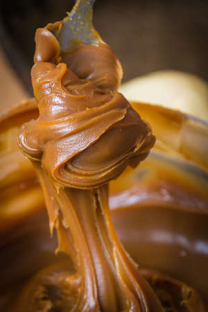 Spoon with boiled condensed milk. Twirls. Large view.の写真素材