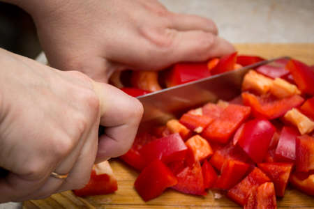 Close up of hands cutting vegetables with a knife. Foodの写真素材