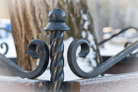 Fragment of forged bench. Winter. Background tree Artの写真素材