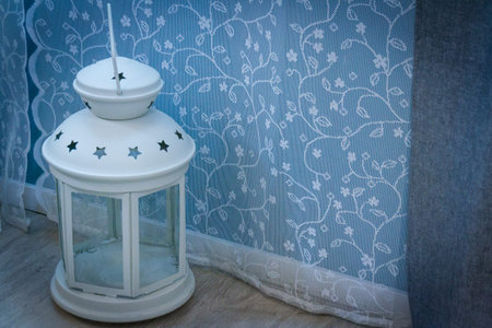 Aroma lamp on the floor against the window and curtains.の写真素材