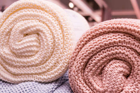 Multi-colored knitted plaids, giant knitted blanket, ultra-short yarn, knitting hands. Interiorsの写真素材