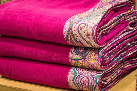 A stack of bright towels with original ornaments. Textile. Bath accessories.の写真素材