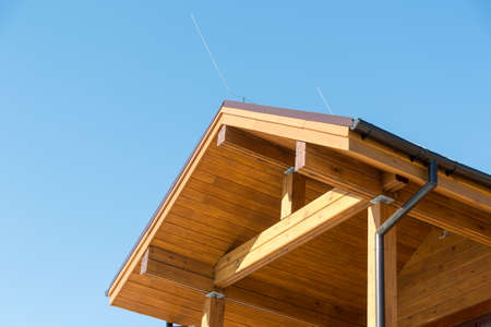 Lightning conductor on a wooden house. Blue sky. Security. Building. Technologiesの写真素材