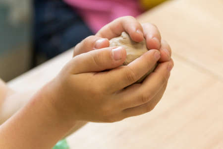 hands make crafts from clay. Creativity. Transformation of clay in crafts. Art.の写真素材