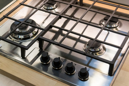 Chrome plate of gas cooker. Four control knobs. Kitchenware. Comfortの写真素材