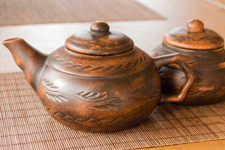 A beautiful clay teapot with an orienic pattern. Tea drinking. Creation.の写真素材