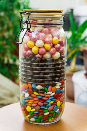 A large container with colorful candies with a tight-fitting lid. Sweets,の写真素材
