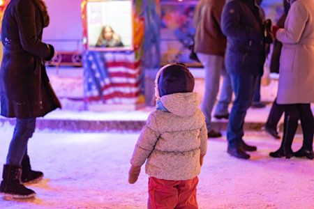 A child is looking to the American flag at the Christmas fair
