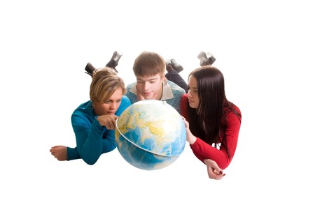 young people looking at globe (isolated on white)の写真素材