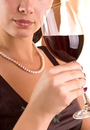 Beautiful young woman with glass of red wineの写真素材
