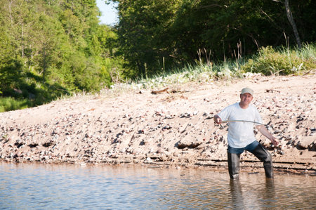 A fisherman fishing on a river