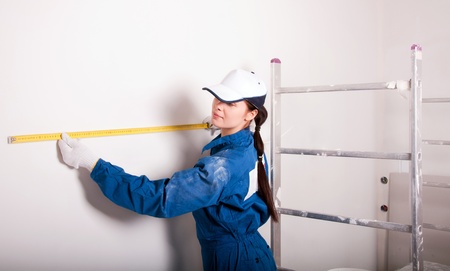 Construction workers at work, measuringの写真素材