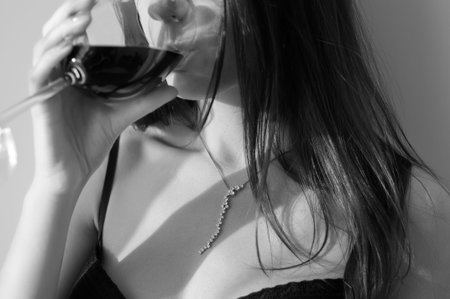 Young woman  with glass of wine の写真素材