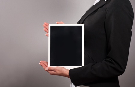 A young businesswoman holding her digital tablet pcの写真素材