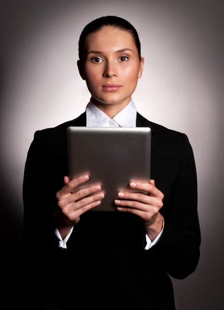 A young businesswoman holding her digital tablet pcの写真素材