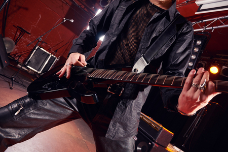 Long haired guitarist is performing on stageの写真素材