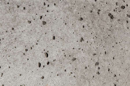 texture of gray cement with small holesの写真素材