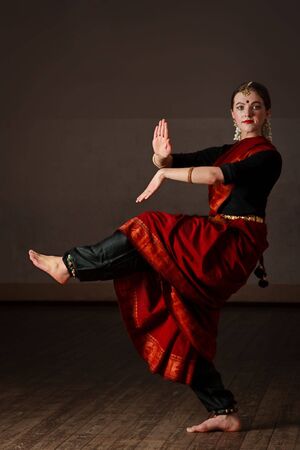 Young woman in sary dancing classical traditional indian dance Bharat Natyamの写真素材
