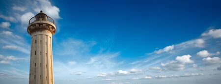 Old lighthouse in the blue sky with copyspaceの写真素材