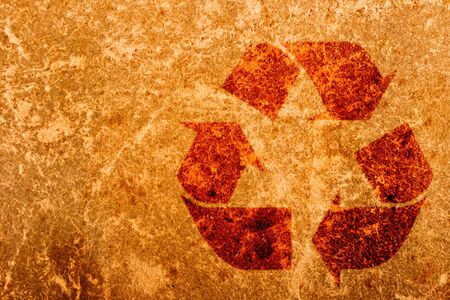 Recycling symbol on old paper texture close up の写真素材