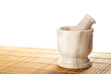 Marble mortar with pestle on bamboo matの写真素材