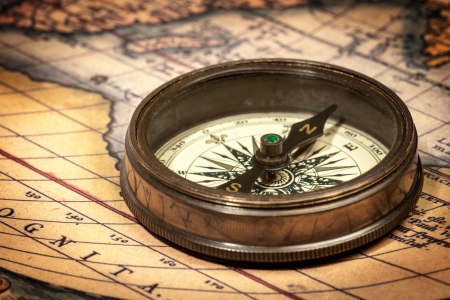 Old vintage retro compass on ancient mapの写真素材