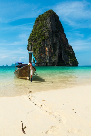 Long tail boat on tropical beach with limestone rock, Krabi, Thailandの写真素材